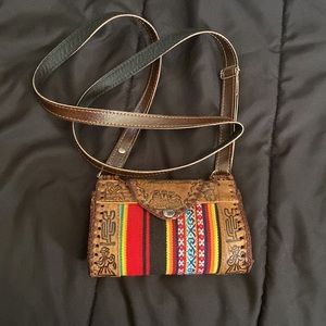 Three T-Shirts, One semi-cropped sweater, One Peruvian leather bag